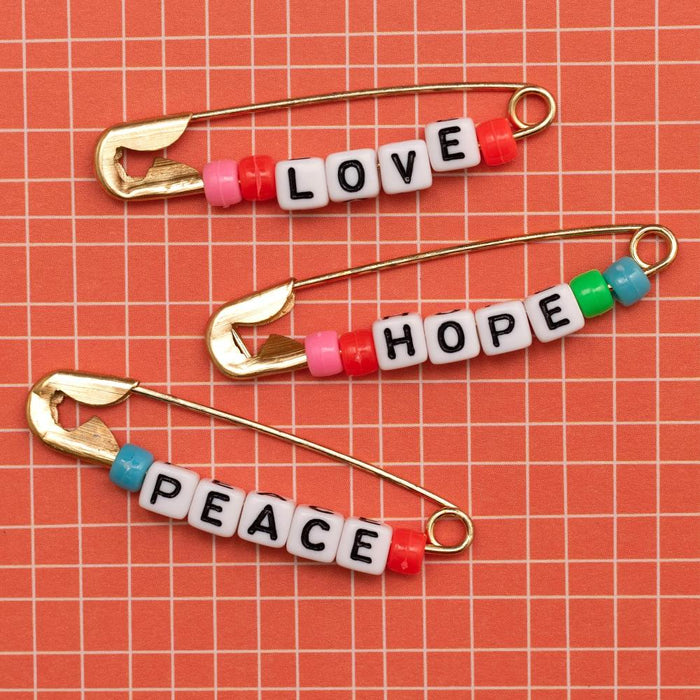 Jen Hadfield | Reaching Out Metal Safety Pins | W/Phrase Beads